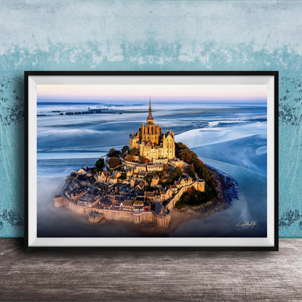 a picturesque island with a castle-like structure on top, surrounded by a body of water.