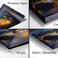The image is a collage of four different views of a bridge at night, with the bridge illuminated by lights. The collage is labeled as "Premium Paper", "Canvas Wrap", "Acrylic", and "Metal/Aluminum".