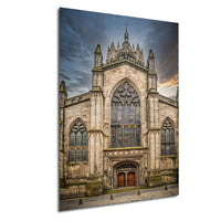 a large, ornate stone church with a tall spire and a stained glass window above the entrance.