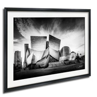 A black and white photograph of the Walt Disney Concert Hall in Los Angeles, California, with its distinctive curved roof and modern architectural design.