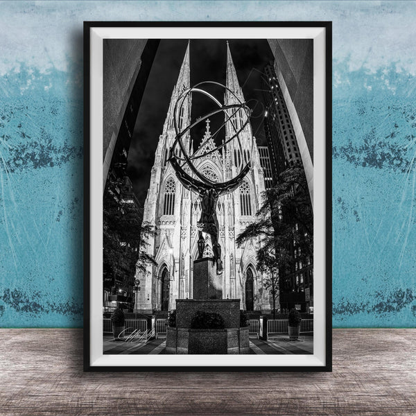 A black and white photograph of a large cathedral with a statue of a man on a pedestal in the foreground, set against a blue wall.