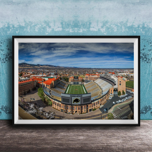 The image is a framed photograph of a football stadium, likely a college or university stadium, with a cityscape in the background.
