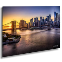 a stunning skyline of a city at sunset, with the iconic Brooklyn Bridge spanning the East River in the foreground.