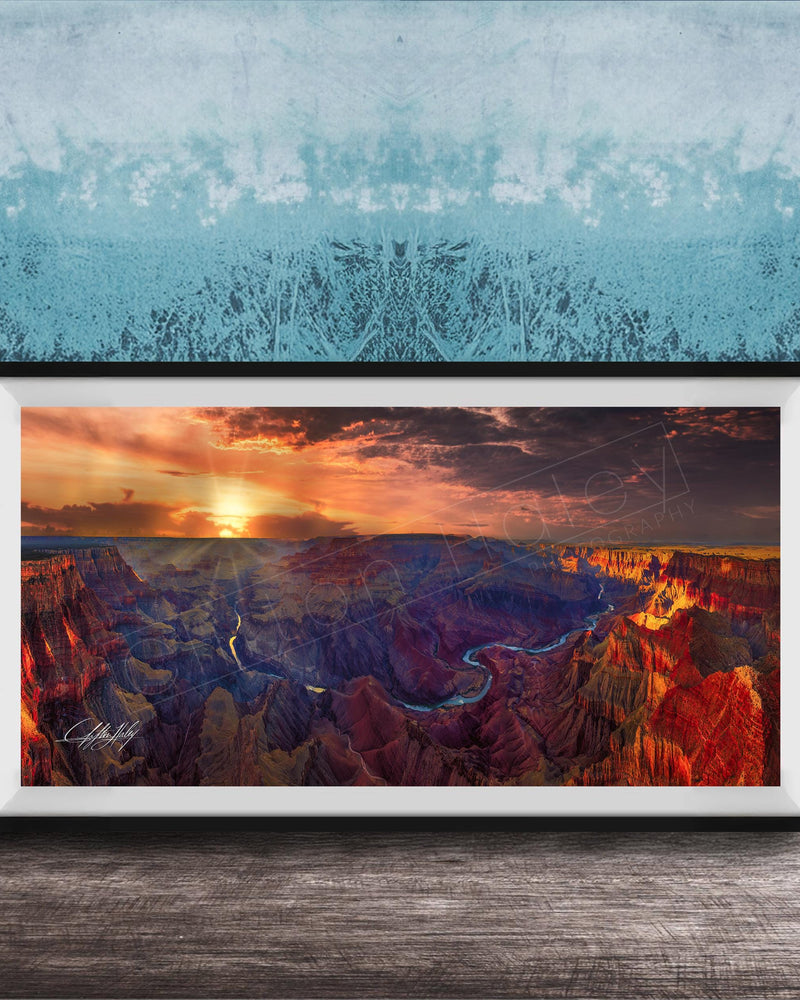 The image is a framed photograph of the Grand Canyon, showcasing the stunning landscape with vibrant colors and dramatic clouds at sunset.