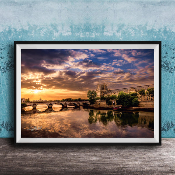 a picturesque scene of a river with a bridge, set against a stunning sunset sky with clouds.