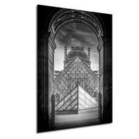 the Louvre Museum in Paris, France, with the iconic glass pyramid structure of the museum prominently featured.