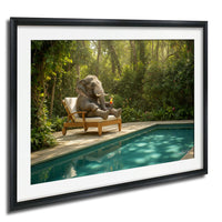 A large elephant sits in a wooden chair on a deck overlooking a swimming pool, surrounded by lush greenery.