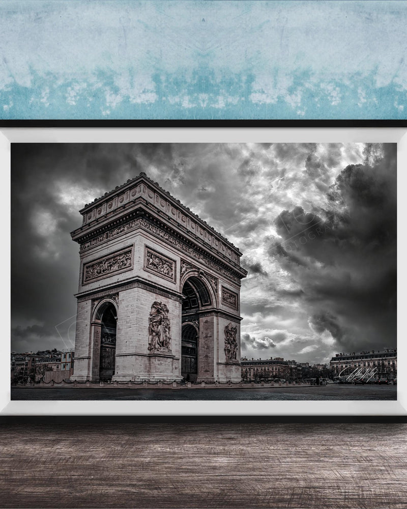 The image is a framed photograph of the Arc de Triomphe in Paris, France, with a dramatic sky in the background.