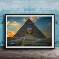a large, ancient Egyptian pyramid with a sphinx statue in the foreground, set against a colorful sunset sky.