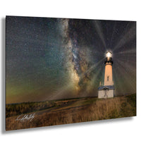 A lighthouse stands in a field under a starry night sky, with the Milky Way galaxy visible in the background.