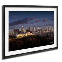A framed photograph of the Los Angeles skyline at night, with the iconic Griffith Observatory prominently featured in the foreground.