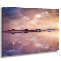 a serene landscape with a calm lake reflecting the vibrant colors of the sky, surrounded by mountains and a stunning sunset.