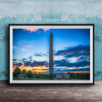 a photograph of the Washington Monument at sunset, with the sky filled with vibrant colors and clouds.