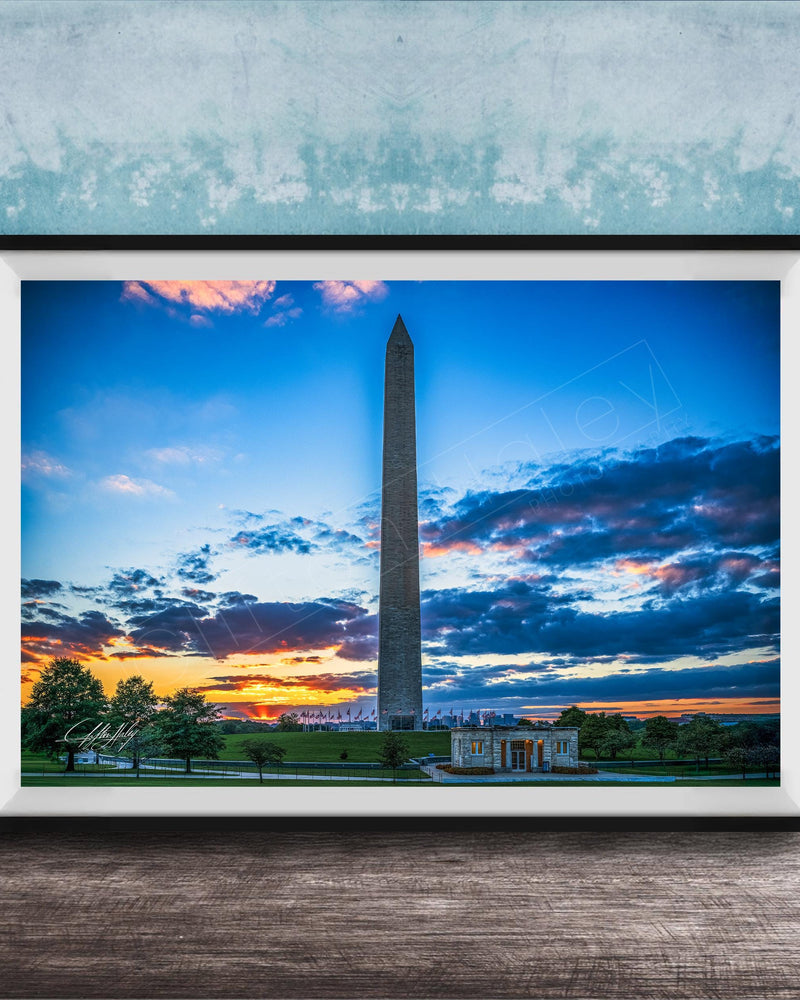 a photograph of the Washington Monument at sunset, with the sky filled with vibrant colors and clouds.
