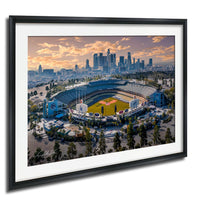 An aerial view of a baseball stadium in a city, with the city skyline in the background.