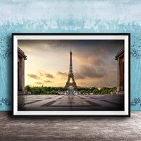 a framed photograph of the Eiffel Tower in Paris, France, with a dramatic sky in the background.