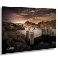 a large dam with multiple spillways, set against a dramatic sky with clouds and a sunset.