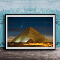 A framed photograph of the Great Pyramid of Giza at night, with a bright star visible in the sky above the pyramid.