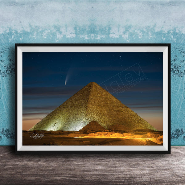 A framed photograph of the Great Pyramid of Giza at night, with a bright star visible in the sky above the pyramid.