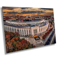 an aerial view of a stadium with a sunset in the background