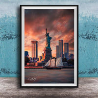 a framed photograph of the Statue of Liberty in New York City, with the city skyline in the background and a sailboat in the foreground.