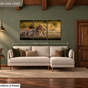 a living room with a large, white sectional sofa and a wooden coffee table. Above the sofa, there is a wall art collage depicting a lion and its cubs in a grassy field. The wall art is framed by a wooden door and a wooden beam ceiling. The living room is described as having a standard 7 foot couch sofa.