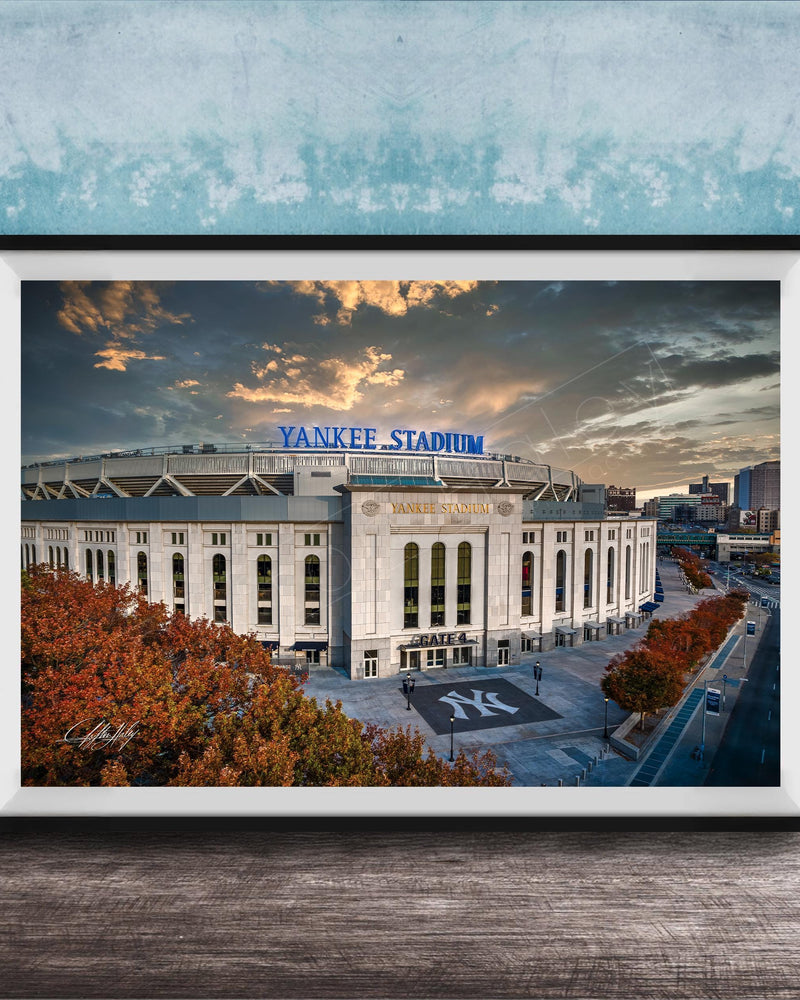 A framed photograph of Yankee Stadium, a baseball stadium located in New York City, with the stadium's name prominently displayed on the exterior.