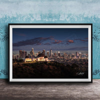 A framed photograph of the Los Angeles skyline at night, with the iconic Griffith Observatory prominently visible in the foreground.