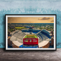 The image is a framed photograph of a football stadium, specifically the dome stadium at Duke Campbell Stadium, with a cityscape in the background.