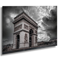a large, ornate archway with intricate carvings and sculptures, set against a dramatic cloudy sky.