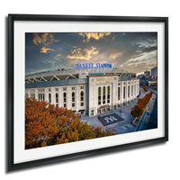 the Yankee Stadium, a baseball stadium located in New York City, with a dramatic sky in the background.
