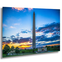 the Washington Monument, a tall obelisk, against a colorful sunset sky with clouds.