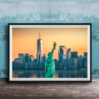 A framed photograph of the Statue of Liberty in New York City, with the city skyline in the background.
