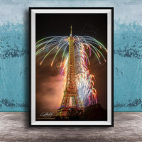 a tall, illuminated tower with a colorful display of fireworks in the sky, creating a vibrant and festive atmosphere.