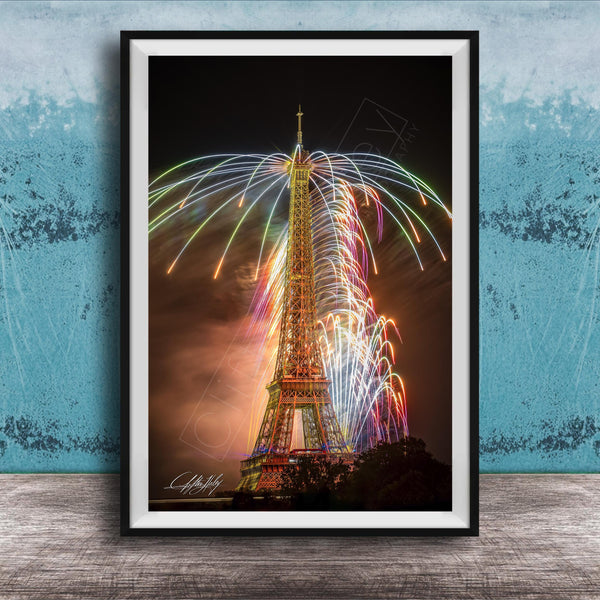 a tall, illuminated tower with a colorful display of fireworks in the sky, creating a vibrant and festive atmosphere.