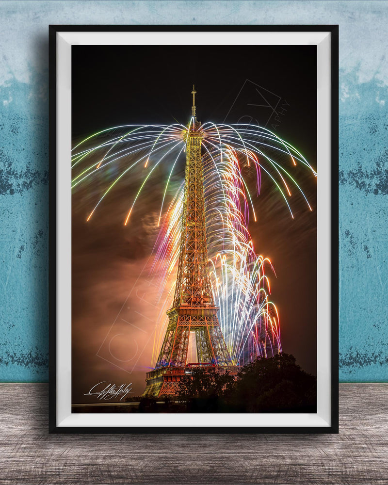 a tall, illuminated tower with a colorful display of fireworks in the sky, creating a vibrant and festive atmosphere.