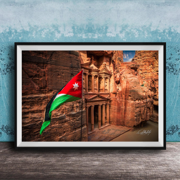 A framed photograph of the ancient ruins of Petra, Jordan, with the national flag of Jordan prominently displayed.