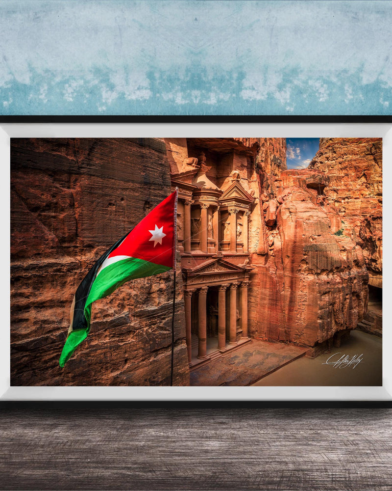 A framed photograph of the ancient ruins of Petra, Jordan, with the national flag of Jordan prominently displayed.