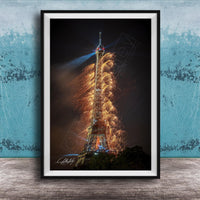 a tall, illuminated tower with a fireworks display lighting up the night sky.