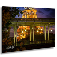 the Eiffel Tower at night, with its intricate iron lattice structure illuminated against a dark sky.