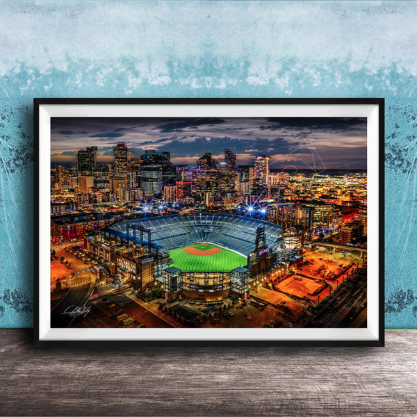 A vibrant nighttime cityscape with a baseball stadium in the foreground, surrounded by illuminated buildings and skyscrapers.