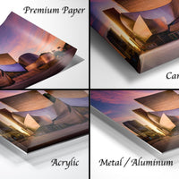 The image is a collage of four different views of a building at sunset, each with a different description: "Premium Paper", "Canvas Wrap", "Acrylic", and "Metal/Aluminum".