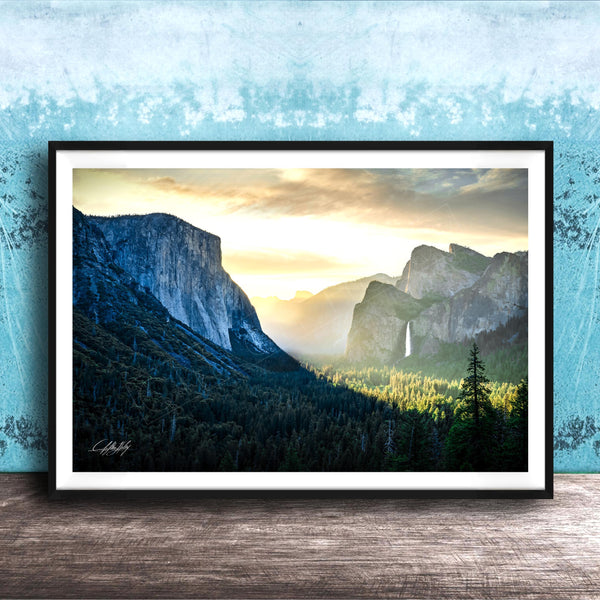 The image is a framed photograph of a scenic mountain landscape with a waterfall, set against a blue and white background.