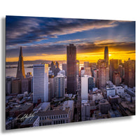 a stunning cityscape at sunset, with a vibrant display of colors in the sky and silhouettes of tall buildings against the backdrop.