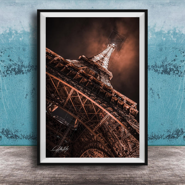 a close-up view of the Eiffel Tower, showcasing its intricate metal lattice structure and the surrounding night sky.