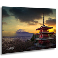 a majestic mountain range with a red pagoda-style temple in the foreground, set against a dramatic sky with clouds and a warm sunset glow.
